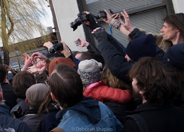 People trying to shake Bernie Sanders' hand at a campaign rally in Brooklyn